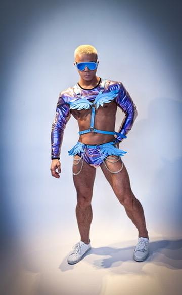 Damon posing in a purple go-go dancer outfit during a studio photoshoot in Vancouver